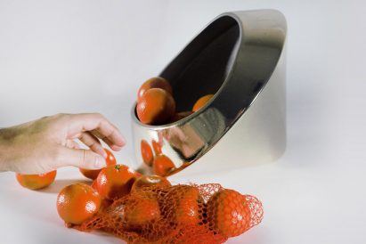 a silver bowl with oranges in it