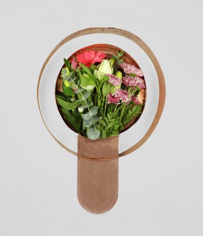 a copper vessel holding flowers