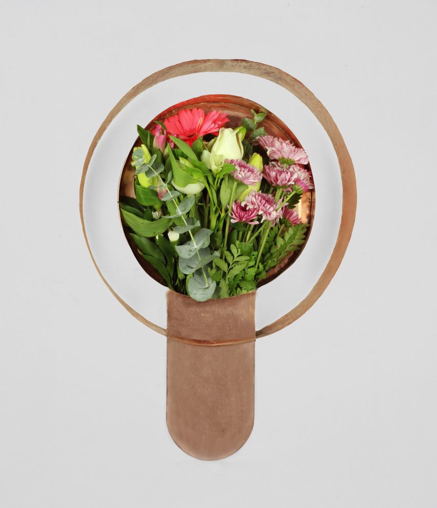 a copper vessel holding flowers