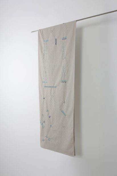 a hanging tapestry in tones of white and blue