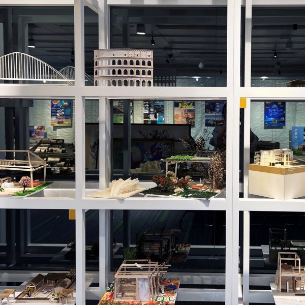 a photograph of a shelf with architectural models on it