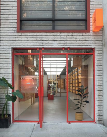 A store exterior with the steel frame around the doors and windows painted red