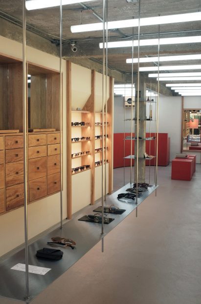 A long shelf hung from rods to display eyewear