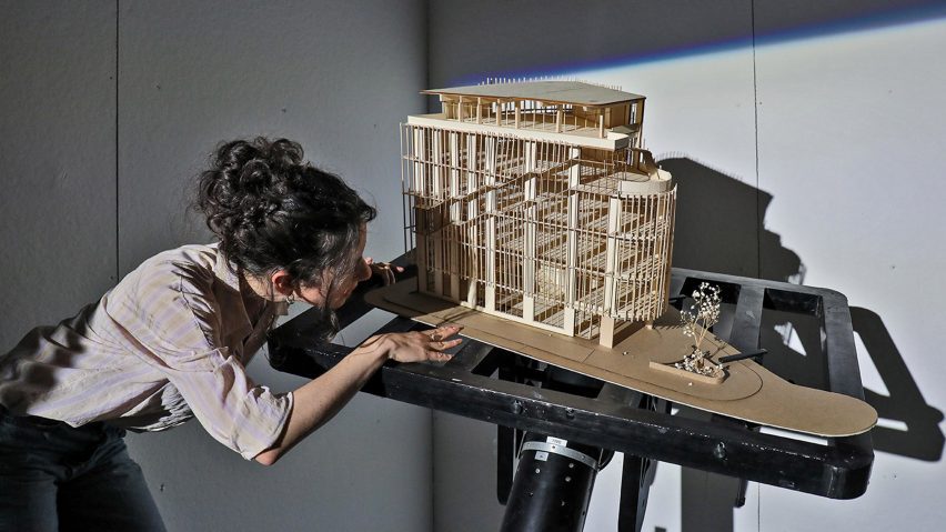 a photograph of a person handling an architecture model