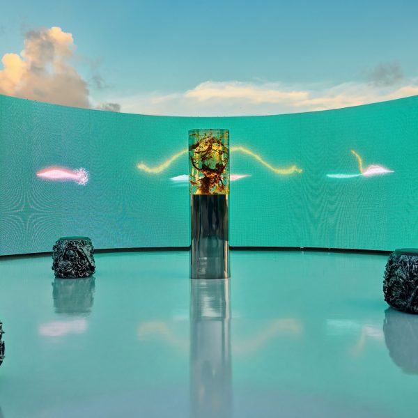 Daytime view of the Plant Pulses installation with a curved turquoise LED screen framing the resin sculpture on Miami Beach