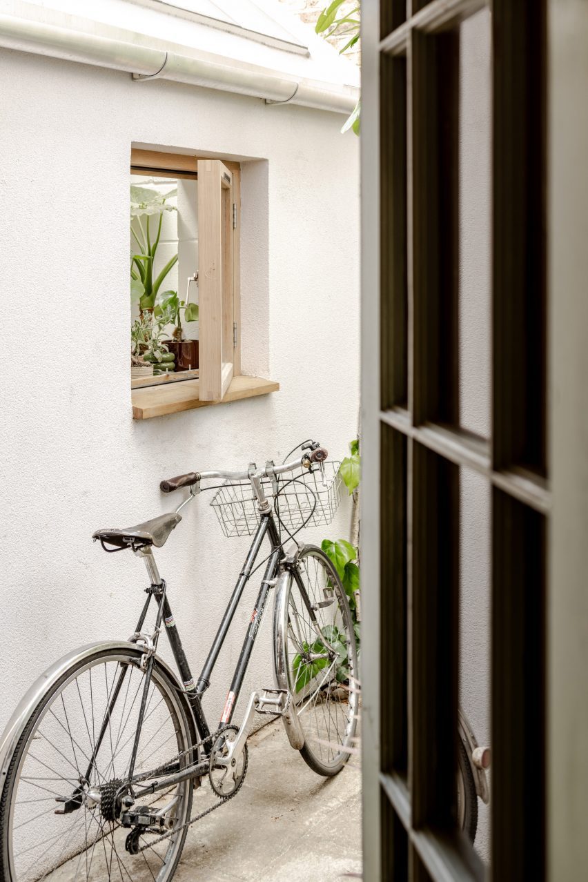 Bicycle leans against a window in A Simple Addition by OEB Architects