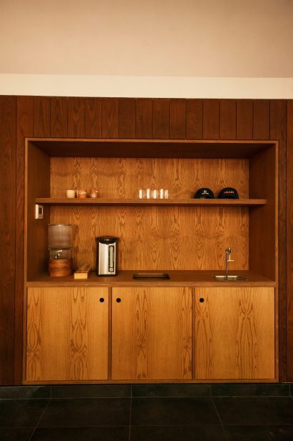 A built-in wooden station providing refreshments and displaying merchandise