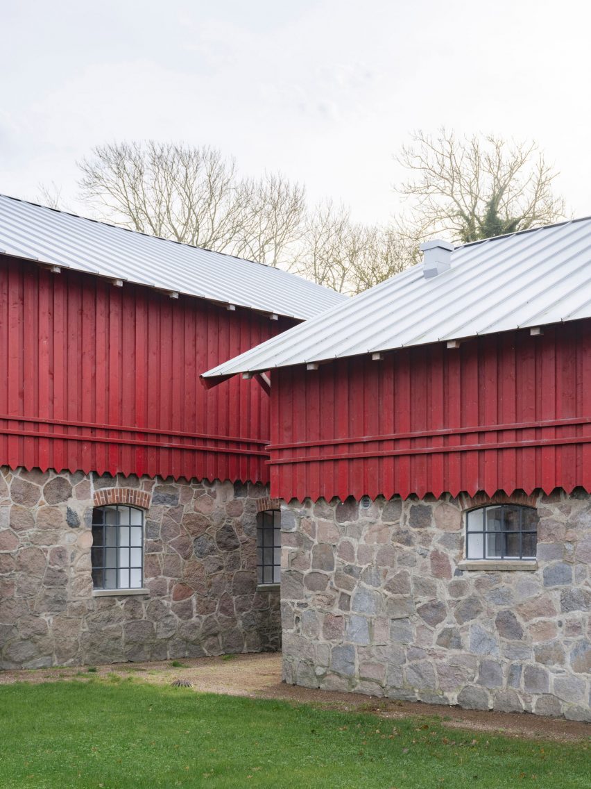 Red-painted timber and stone walls of Michael Kvium's studio, a historic barn restored by architect Martin Schack
