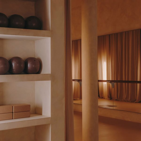 Barre studio with floor-to-ceiling curtains and mirrored walls