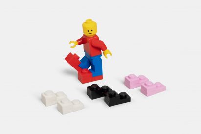 Lego mini figure wearing oversized shoes