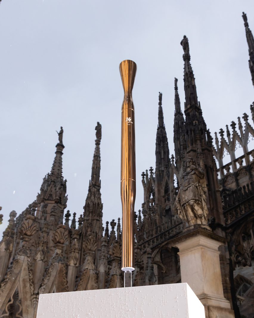 Bronze-coloured torch in front of church