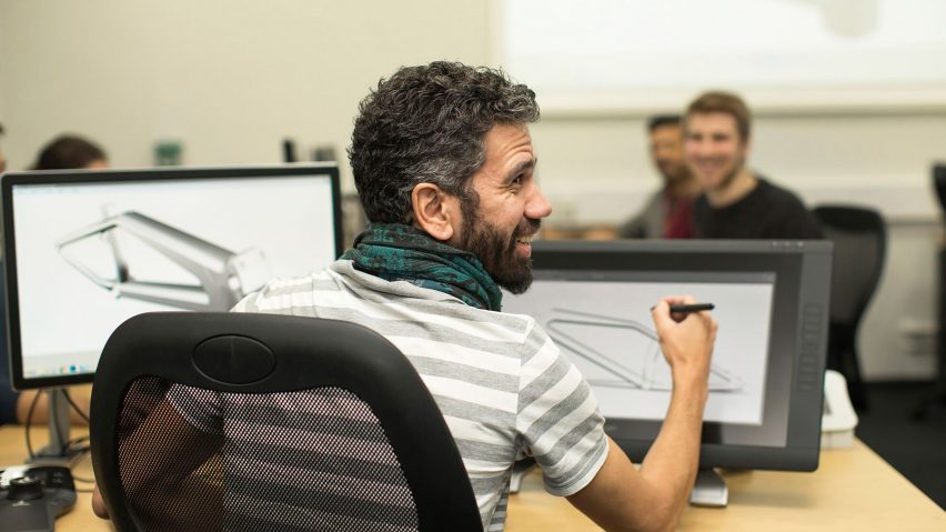 a photograph of a person at a desk