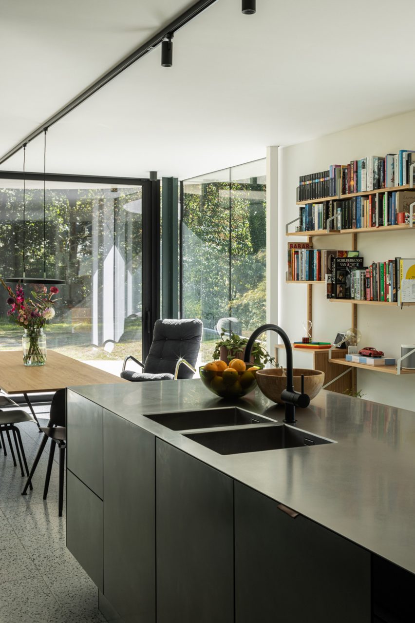 Stainless steel kitchen island and floating bookshelves