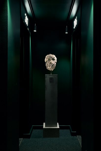 White sculpture in green corridor