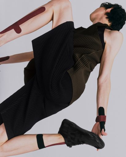 Person wearing black Hyper Taping trainers by Issey Miyake