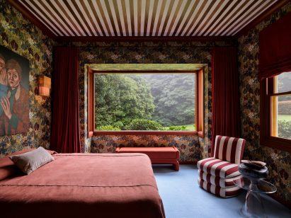 Bedroom with striped ceiling and patterned red wallpaper
