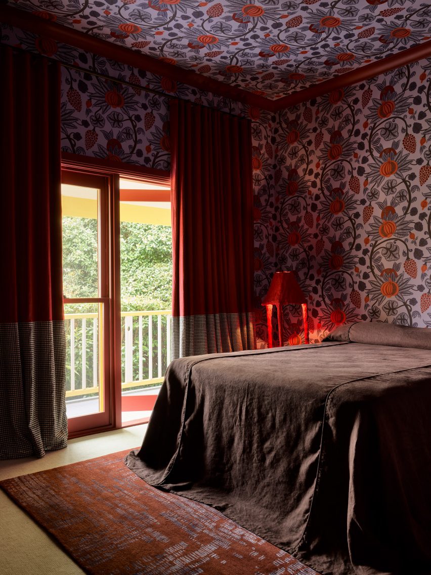 Bedroom with red patterned wallpaper