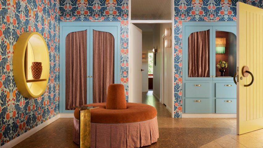 Room with patterned walls and pale-blue wardrobes