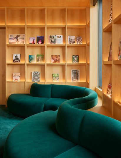 Wood-panelled library with dark green carpets and built-in seating