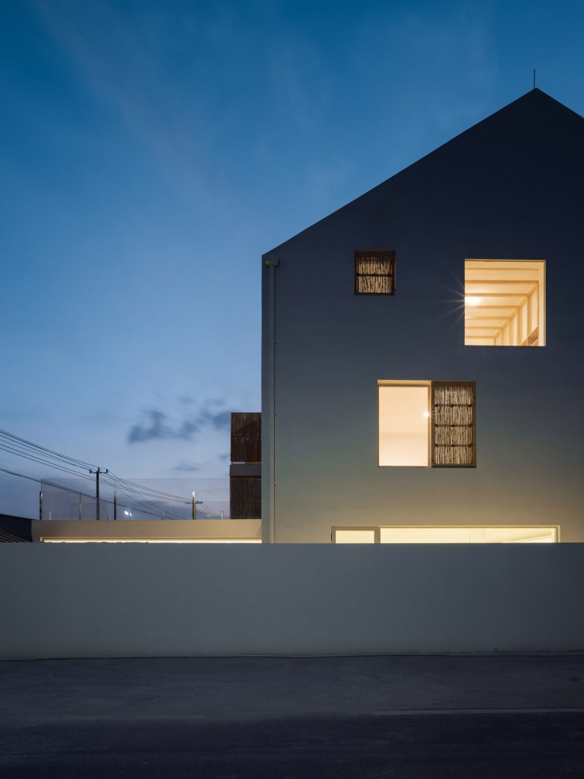 Rural guesthouse with windows lit up at night