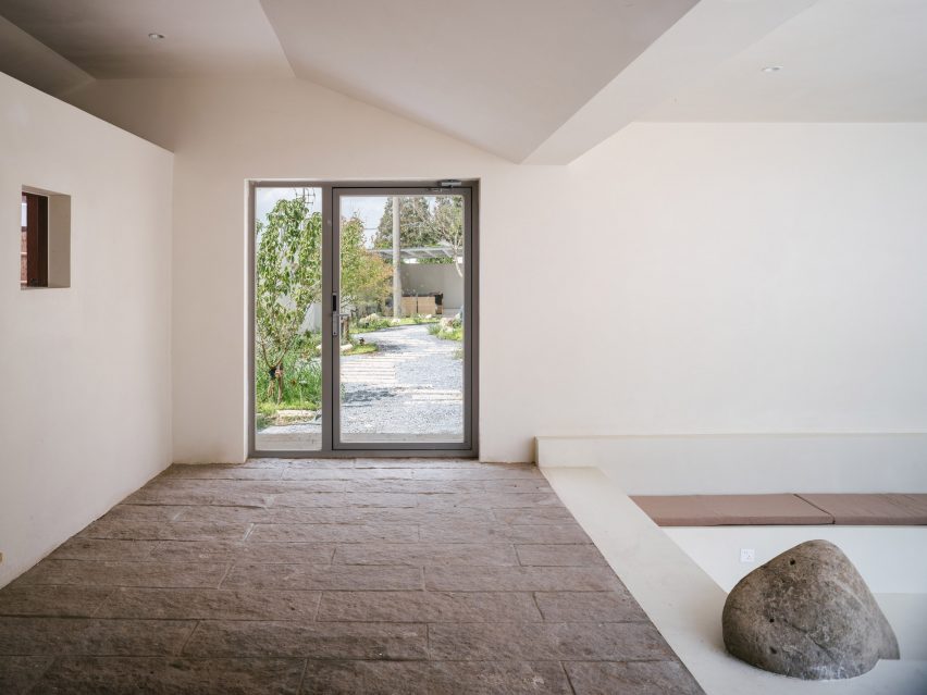 Lobby with stone floor and sunken seating area