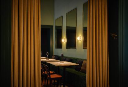 Antique mirrors and banquette seating in a bistro-style dining space