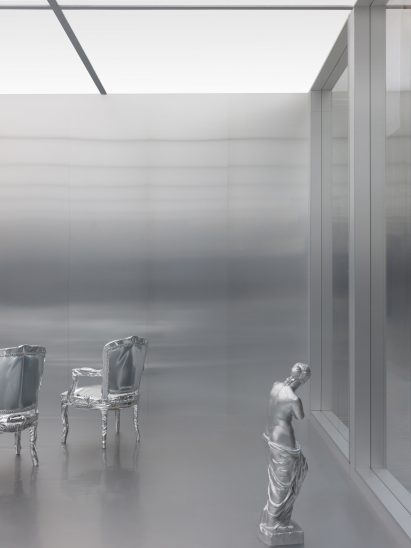 Silver statue and chairs in a silver room