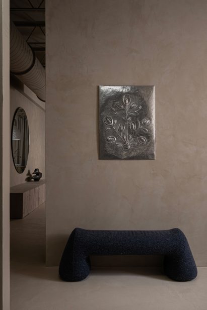 Bench by Victoria Yakusha under metal wall ornament