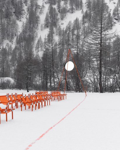 Orange football pitch in snowy landscape