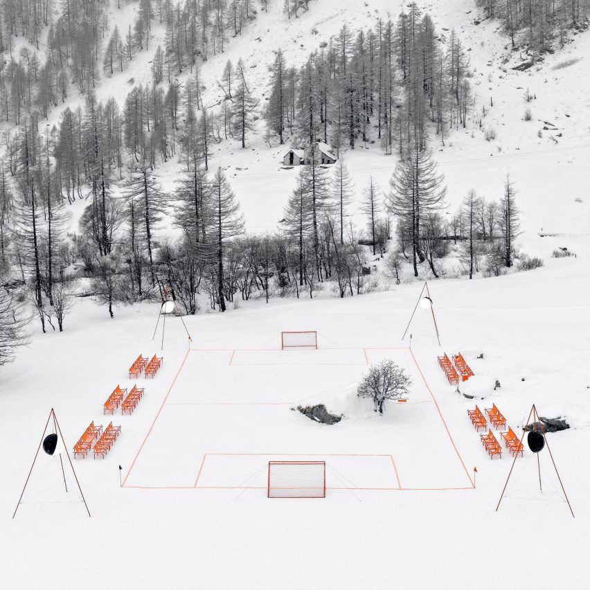 Orange football pitch in snowy landscape