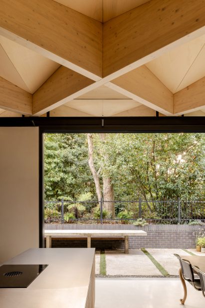Kitchen with exposed timber diagrid roof in Arbour House by Andrei Saltykov
