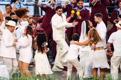Bad Bunny dancing with guests and musicians at a wedding party