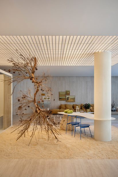 A hanging branch sculpture by Aline Matsumoto positioned in a winter garden space