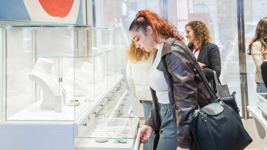 person looking at jewellery in glass displays