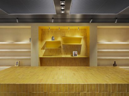 Stainless-steel ceiling anf yellow tiled desk