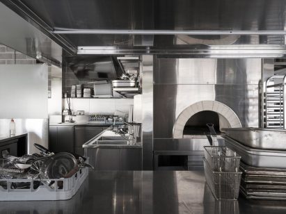 Restaurant kitchen with white brick pizza oven