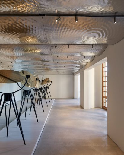 Art gallery with wavy metal ceiling