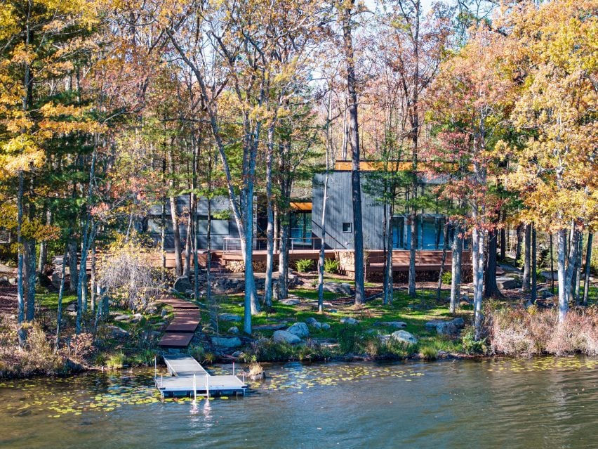 Photo of the Mountain Home in Hawley by EMAKI seen from a distance through trees and over a lake