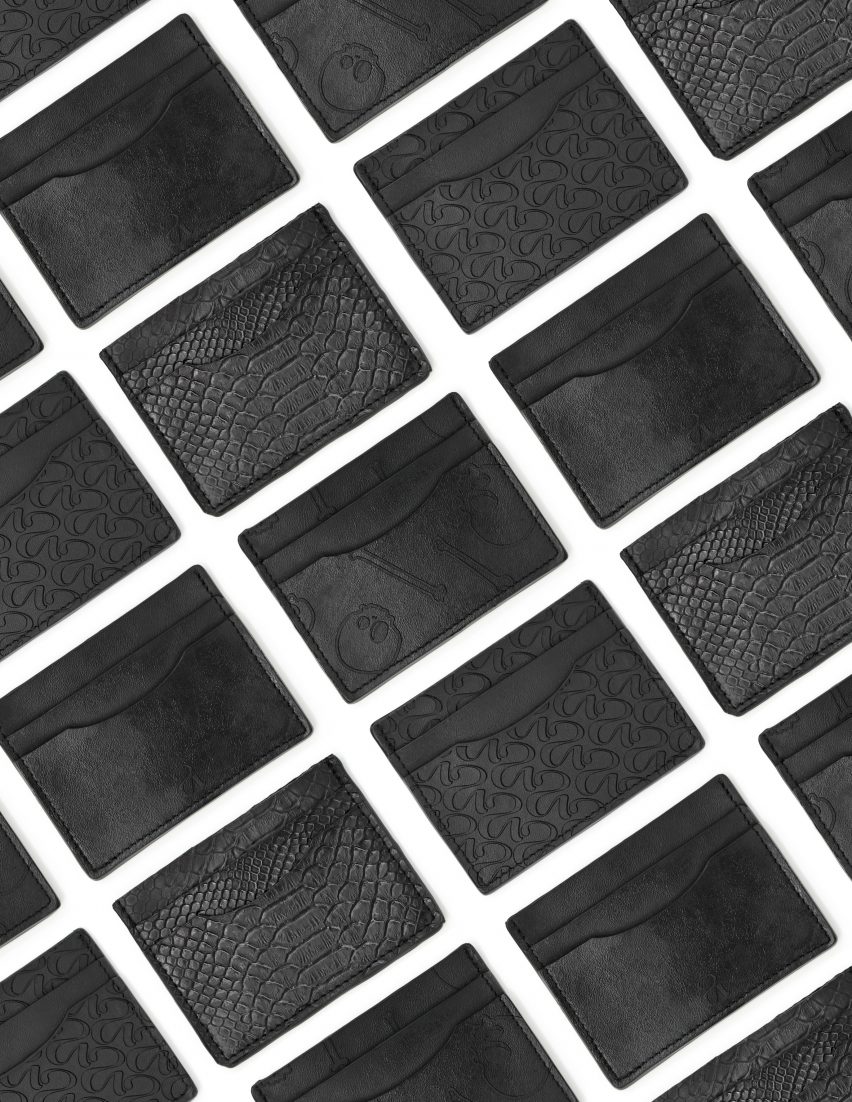 Photo of rows and rows of small card wallets made of black leather-like New Grain material debossed with different designs