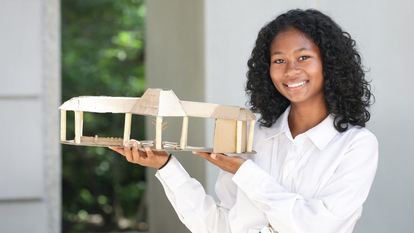 person holding an architecture model