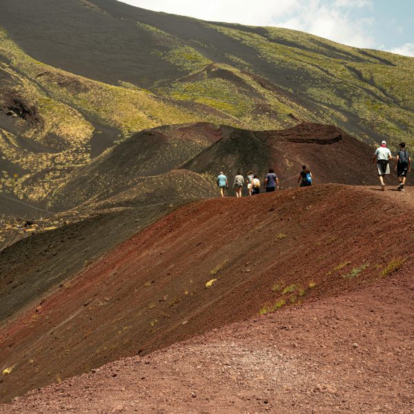 Landscape with people walking over a hilltop
