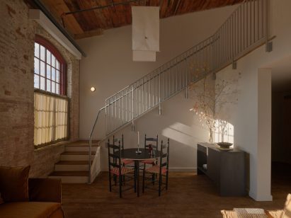 A two-storey Loft Suitewith a staircase leading to a mezzanine level