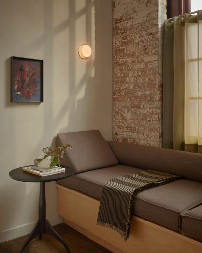Built-in bench seat with grey cushions below a window