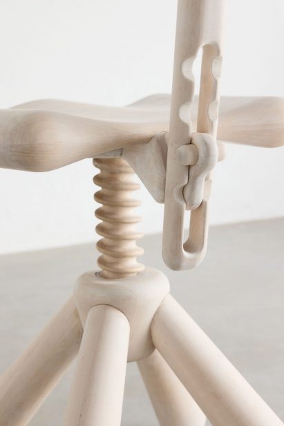 Close-up of wooden screw and height adjuster on office chair