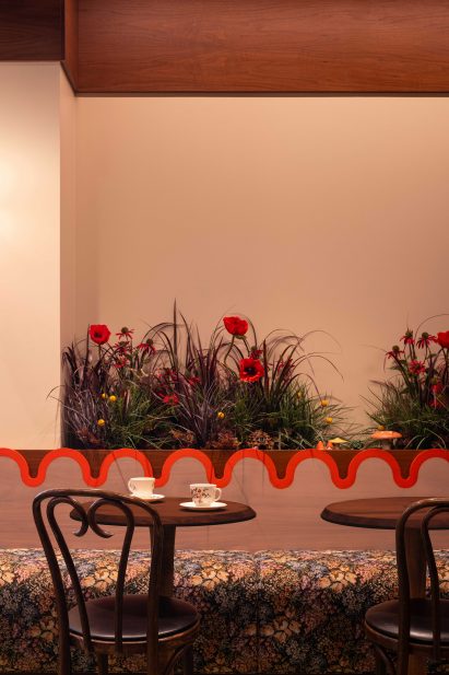 A floral-upholstered banquette and vintage bentwood chairs