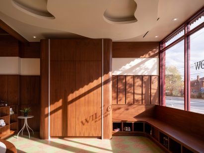 Walnut benches with cubby holes under a window