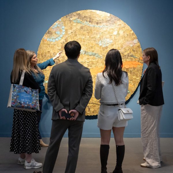 people looking at an art piece in a gallery
