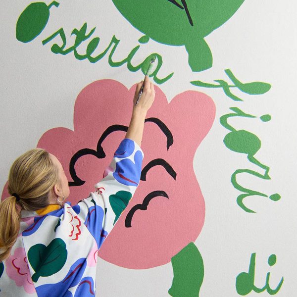 Woman painting over exhibition artwork