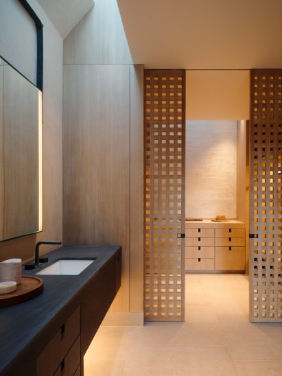 A skylights and void brings in light from above to a bathroom and dressing room
