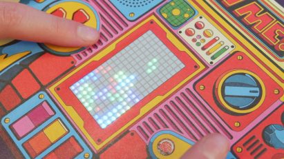 Close-up of fingers playing a paper Tetris game